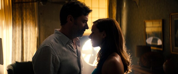 This image released by Warner Bros Pictures shows Hugh Jackman, left, and Rebecca Ferguson in a scene from Reminiscence.