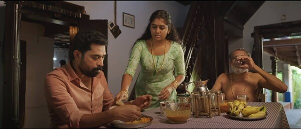 Suraj Venjaramoodu (left) and Nimisha Sajayan (center) in The Great Indian Kitchen.