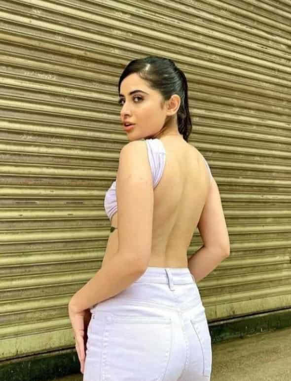 The Daayan fame actress sports a backless white top with a white pair of jeans and mesmerises her fans.