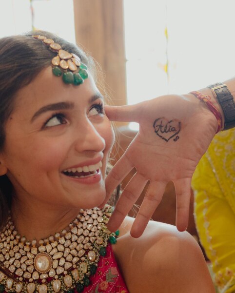 Ranbir flaunted Alia's name on his hands during the event, while the latter smiled and adorably looked at him.