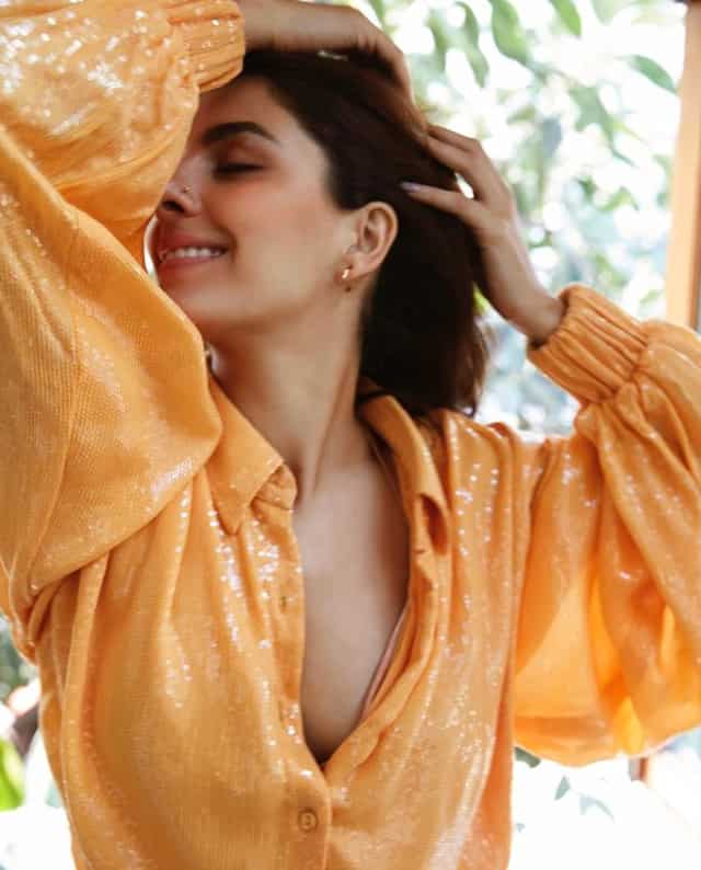 The Sharmaji Namkeen actor mesmerises fans in her sexy orange shirt.