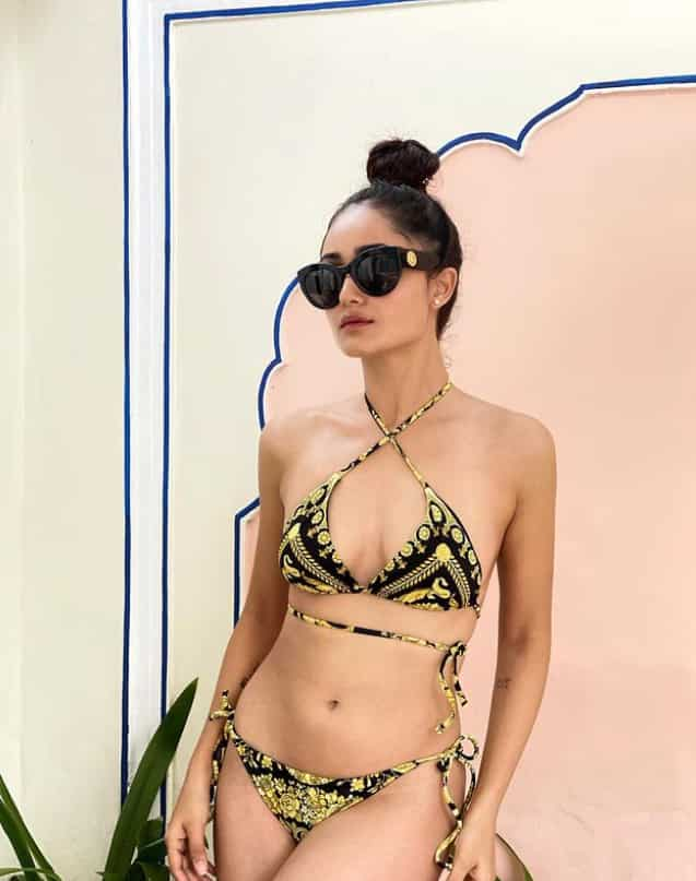 The Bandish Bandits actress ups the beachwear fashion with her yellow black to piece bikini. 