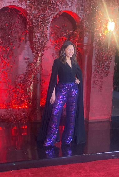 Madhuri Dixit arrived at the party in shimmery blue-purple pants and a beautiful black blouse.