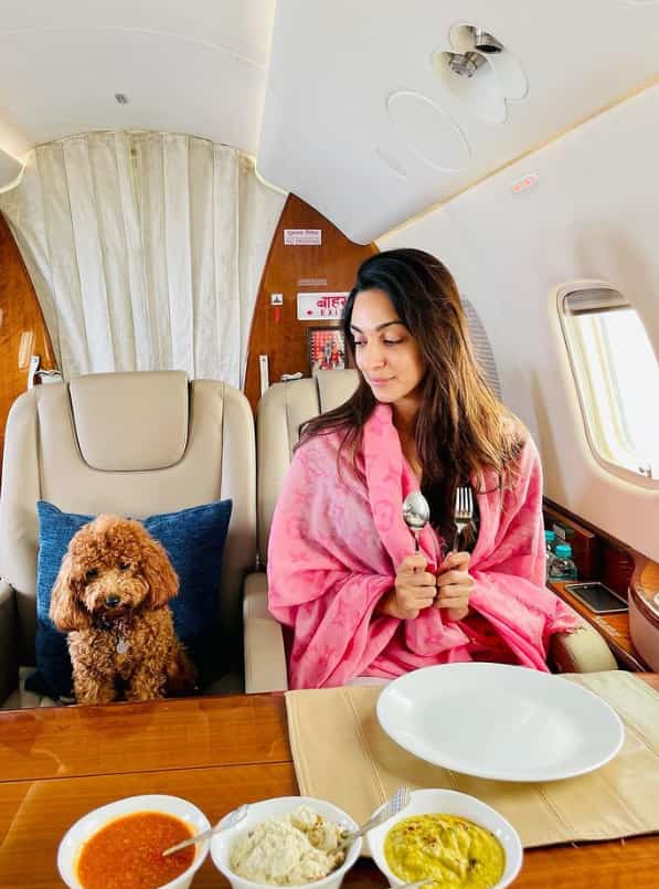 Amid the busy schedules of promotions, Kiara shared an image on her Instagram handle having breakfast on a flight beside her adorable pet dog.