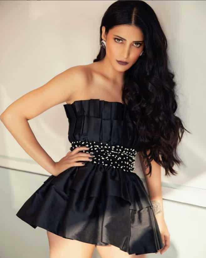 Shruti's cute black ruffle dress makes her look like a doll.