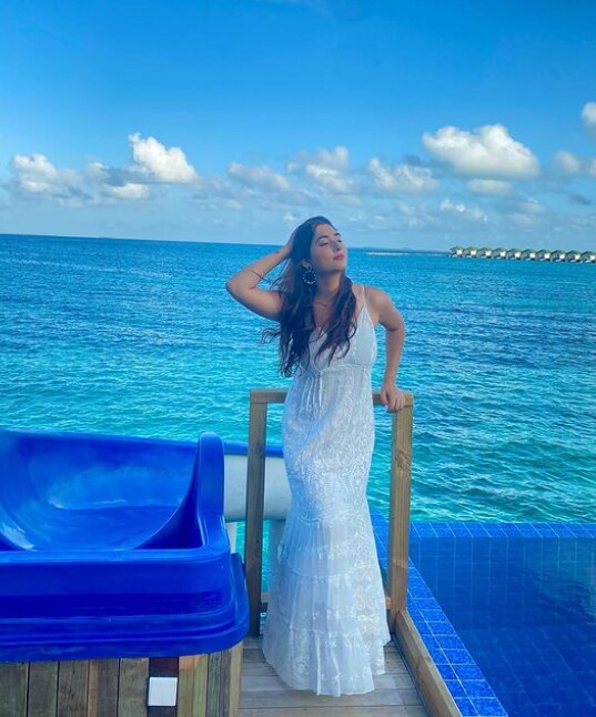 Apart from bikinis, Disha's long white dress makes her look like a mermaid beside the ocean.