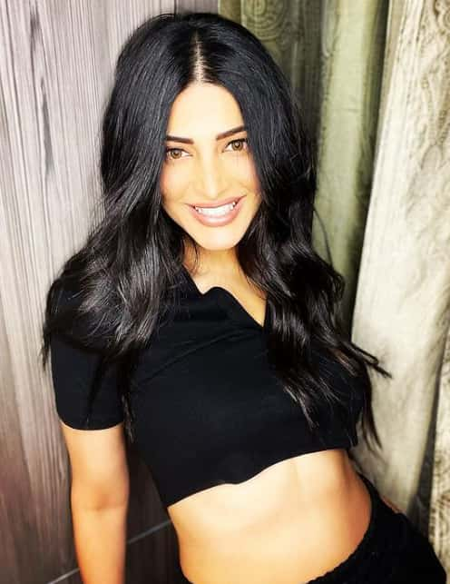 Shruti's million dollar smile in a black crop t-shirt with black bottom.