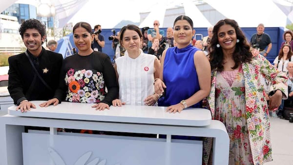 Payal Kapadia (center) with the film's cast at the Cannes photo call