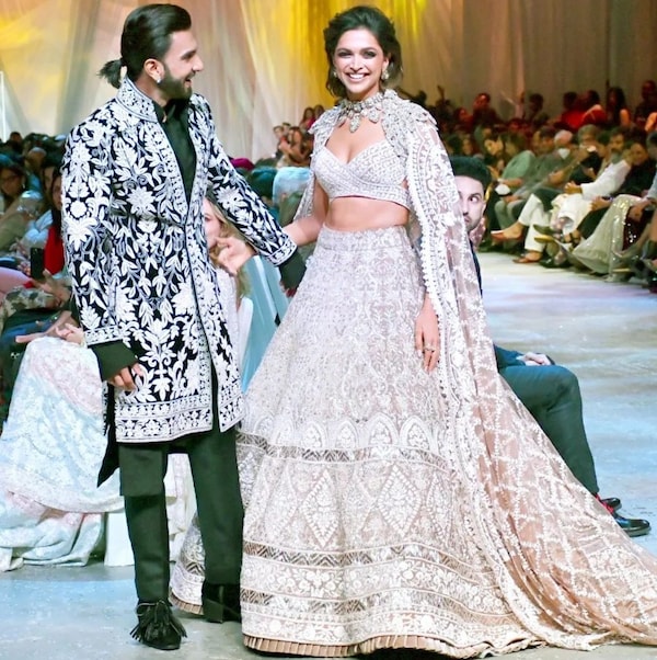 Deepika Padukone and Ranveer Singh appear to be having a good time as they walk the runway together