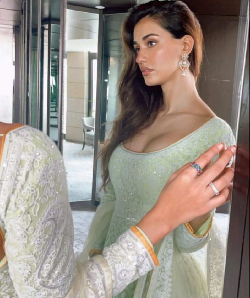 7. Disha wore a pastel Anarkali. She looked gorgeous with her hair let loose and subtle earrings. She posed looking at the mirror, presenting her glamorous look.