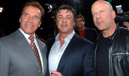 Which of these restaurant chains did Stallone own along with two men in this picture?