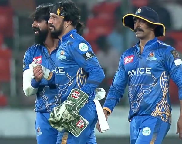 Karnataka Bulldozers have a happy moment on the field in their match against the Chennai Rhinos