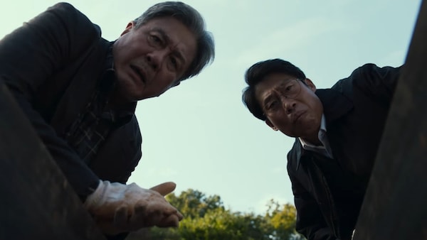 Choi Min-sik and Yoo Hai-Jin in a still from Exhuma