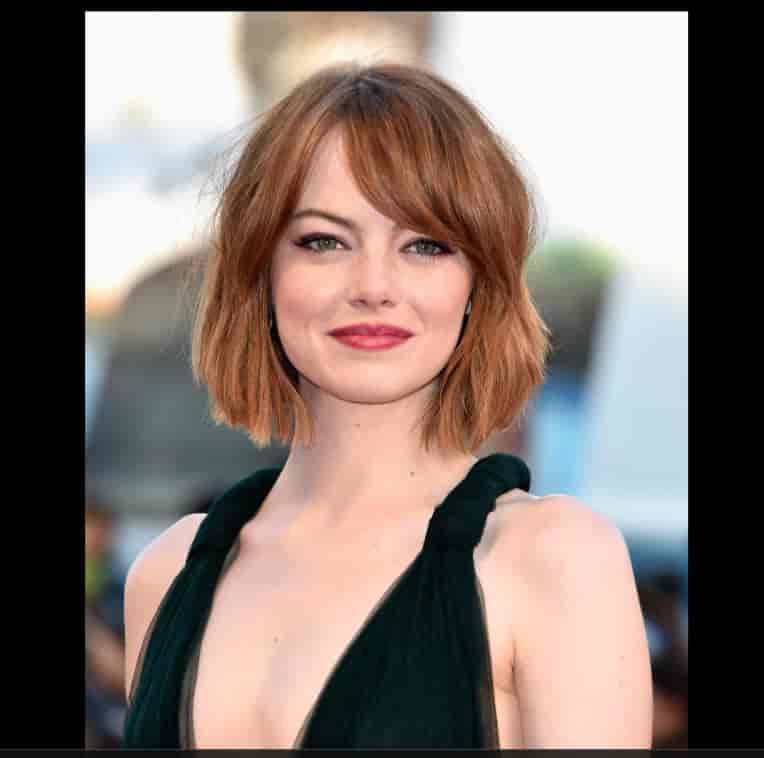 Emma Stone's low-pitched husky voice results from which condition she had as an infant?