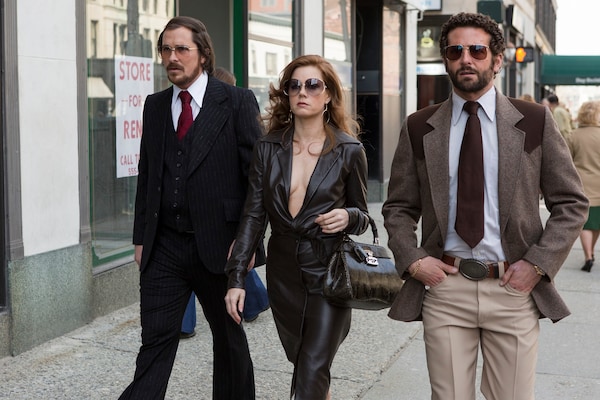 Christian Bale, Amy Adams, and Bradley Cooper in a still from American Hustle