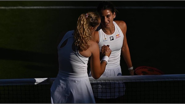 Mirra Andreeva and Emma Navarro at the net.