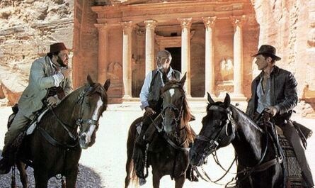 In the movie Indiana Jones and the Last Crusade, the four horses used in the concluding moments outside the temple were personally lent to the film by the monarch of which country?							