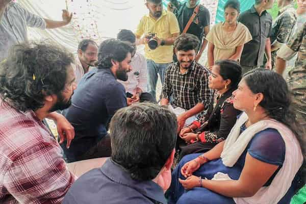 Naga Chaitanya interacts with a fisherman's family