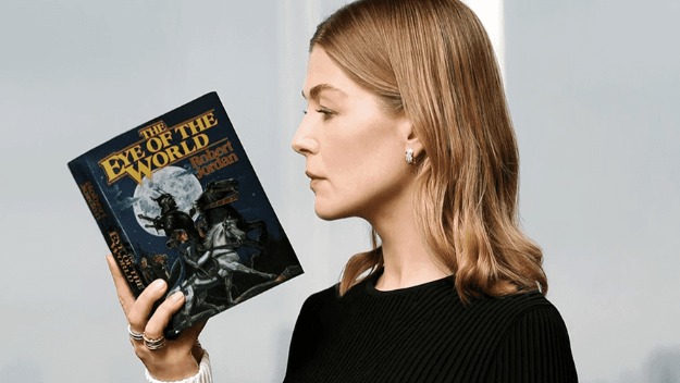 Rosemund Pike with the first book of the Wheel of TIme series