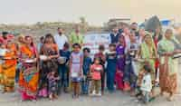 EXCLUSIVE photographs of Dewas residents distributing rice from Sonu Sood’s giant portrait, to the poor and needy