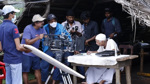 Santosh Sivan and Mammukoya on the sets of Olavum Theeravum