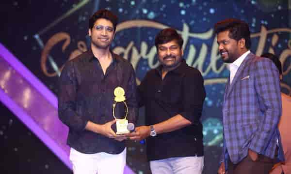 Chiranjeevi presents an award to Adivi Sesh