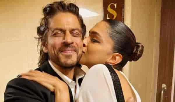 Check out Shah Rukh Khan’s PRICELESS reaction as Deepika Padukone plants a kiss on his cheek!