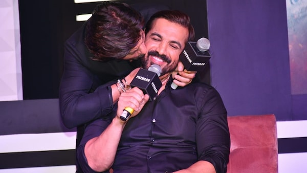 Shah Rukh Khan surprises John Abraham with a peck on his cheek, and we are loving this Pathaan bromance