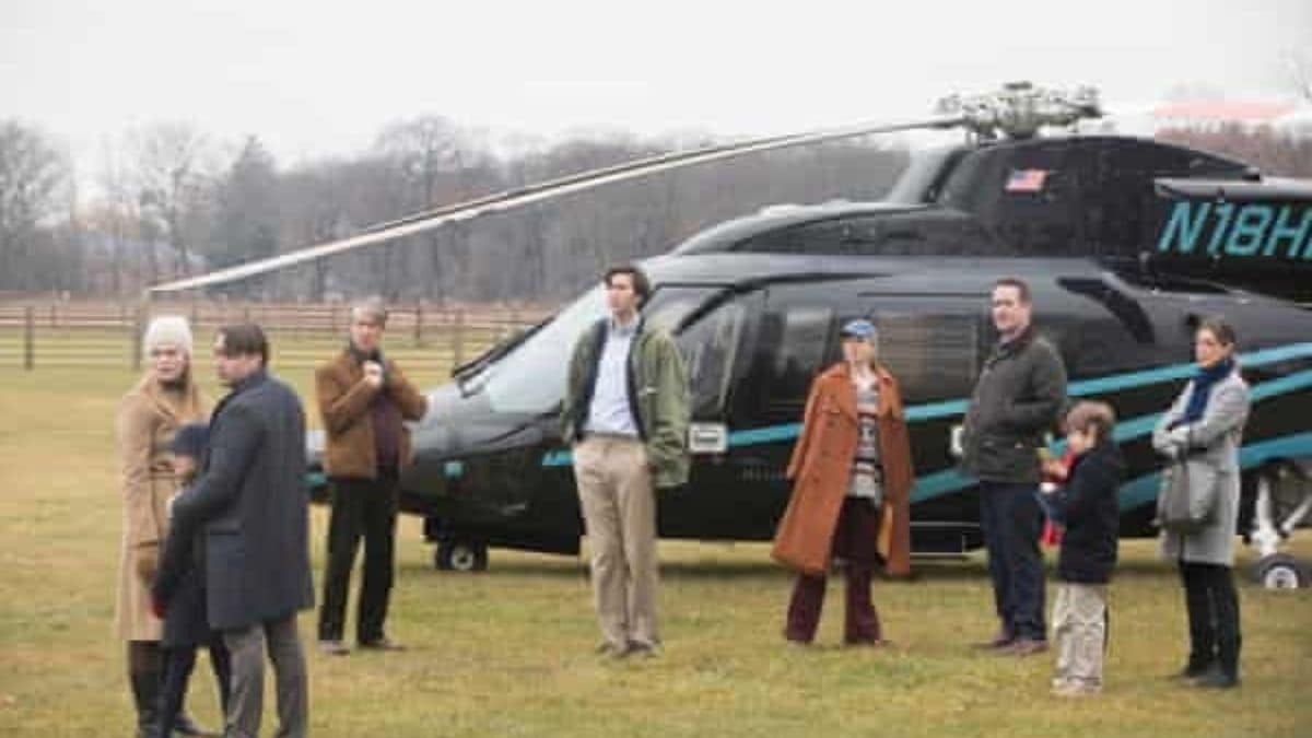This particular scene involved the Roy family engage helicopters and luxury cars to do what activity?
