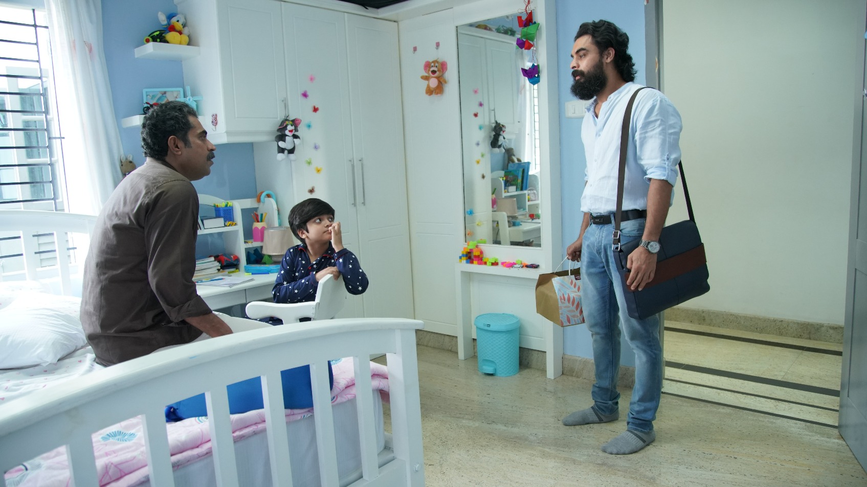 Suraj Venjaramoodu, Master Alok Krishna and Tovino Thomas in a still from Kaanekkaane