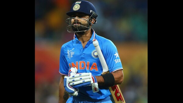 Virat Kohli walks back to the pavilion after being dismissed for 1 by Australia's Mitchell Johnson